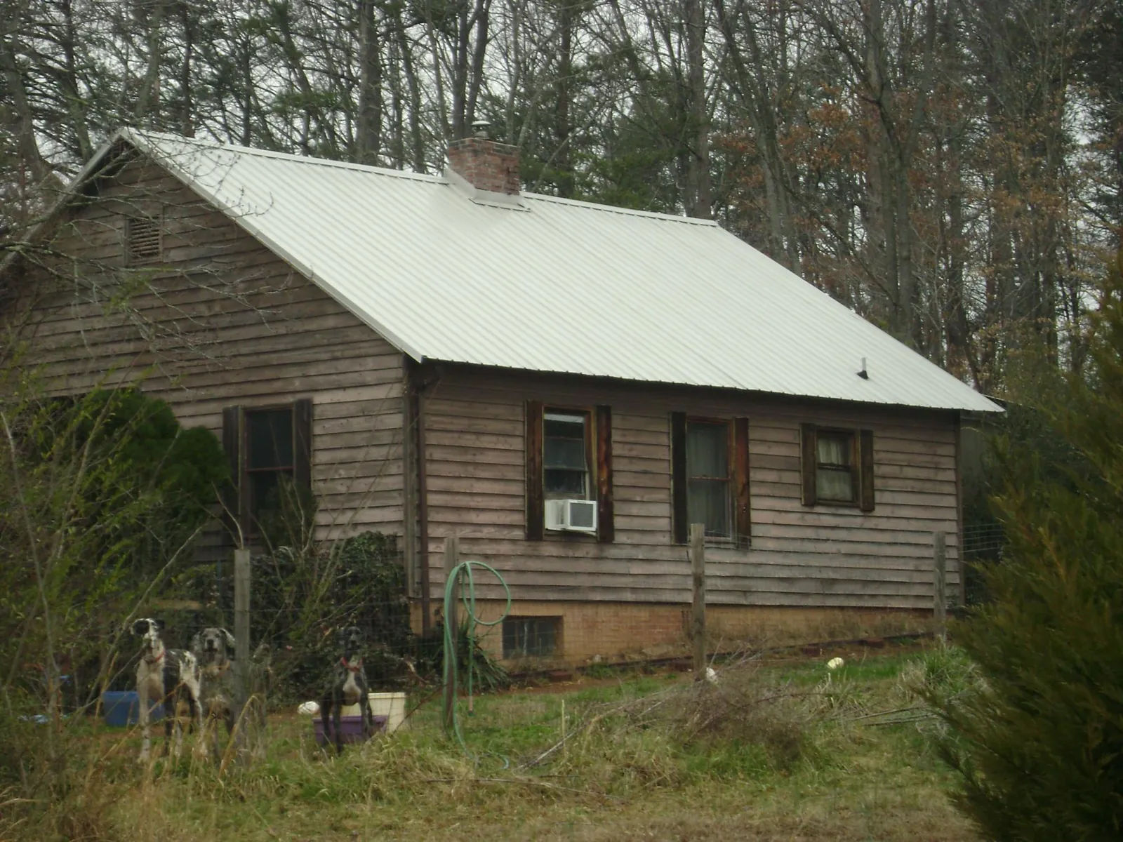 White metal roof on an old wood sided farmhouse, from a Metal Roof Installation job in Freeman